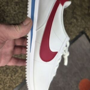 Nike White Sneaker with Red Swoosh and Blue Heel Accent